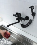 Wall Mount Kitchen Faucet In Matte Black With Side Sprayer, Heavy Duty Stainless Steel Commercial Mixer Tap over a sink, hand washing apple