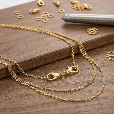 Gold double end lobster clasp from 20 Pcs Double End Lobster Clasp Set For DIY Jewelry Making on wooden surface with chains