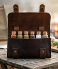 Leather Spice Wallet And Camping Spice Kit For Travel Seasoning Rack With Six Corked Vials on a wooden table outdoors
