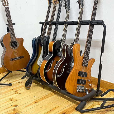 Guitar stand with acoustic and electric guitars on a wooden floor