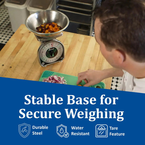Person using Mechanical Dial Scale For Kitchen And Restaurant 2 Pound Capacity Battery Free Accuracy Large Easy Read Dial Durable Metal Construction Ideal For Food Prep Cooking And Portioning In Busy Kitchens on counter with food