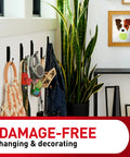 Command wall hooks on white wall holding bag, jacket, keys and accessories in entryway