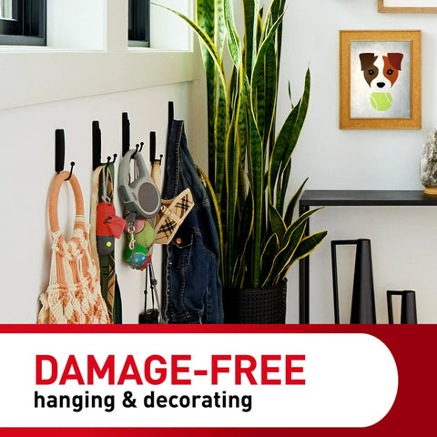 Command wall hooks on white wall holding bag, jacket, keys and accessories in entryway