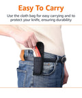 Side view of folding utility knife in black belt sheath on hip; red handle visible.