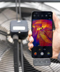 Hand holding Android phone with iSee Mobile Thermal Camera displaying thermal image of a fan, real-time 25Hz imaging for inspections.