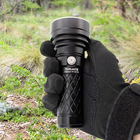 Person holding Catapult V6 SST70 USB C Rechargeable Flashlight With 2836 Lumens And 692m Beam Distance in a forest setting.