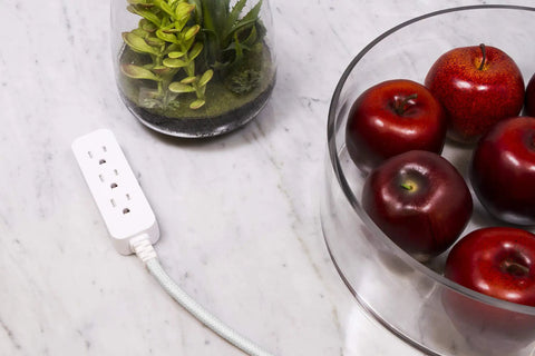 5 Pack 3 Outlet Power Strip With Surge Protection Grounded Flat Plug 6 Inch Designer Braided Cord near apples on a marble surface