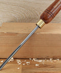 Pro Grade HSS Spindle Gouge Woodturning Chisel with walnut handle and brass ferrule on wood surface, ideal for lathe work.