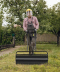 Man using Heavy Duty Lawn Roller 17 Gallons Water Filled Sod Roller With Steel Drum And Ergonomic Handle in park