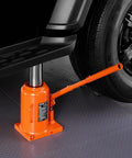 Side view of orange VEVOR hydraulic bottle jack, 50-ton, with long handle under a car.