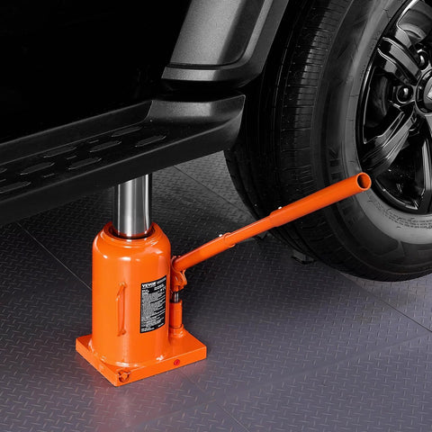 Side view of orange VEVOR hydraulic bottle jack, 50-ton, with long handle under a car.