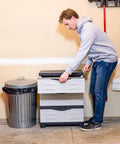 Person using Space Saving 3 Tier Resin Storage Cabinet With Drawers For Garage Office Home And Laundry Room Gray With Charcoal Trim.