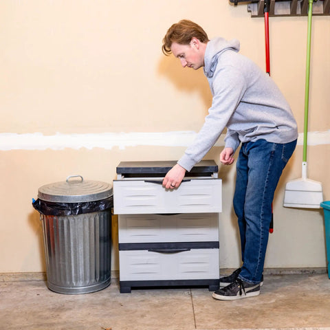 Person using Space Saving 3 Tier Resin Storage Cabinet With Drawers For Garage Office Home And Laundry Room Gray With Charcoal Trim.