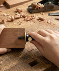 Top Shelf Wheel Marking Gauge with Precision Rolling Cutter utilized on wood for accurate lines, showcasing its dual scale feature.