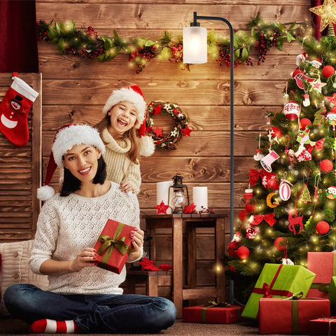 Festive living room with decorated Christmas tree and Gold Floor Lamp Tall Standing Light With Clear Glass Shade For Living Room And Bedroom.