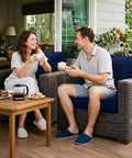 Couple enjoying coffee on patio with wicker sofa featuring Outdoor Chair Cushions Set For Patio Furniture 22 By 22 Inch Deep Seat Cushion And 22 By 19 Inch Back Pillow With Removable Rain Resistant Covers And Ties For Wicker Sofa Blue Sunbrella.