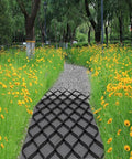 Hardcore Gravel Stabilizer Grid for Patios, Driveways and Slopes installed on path in garden, surrounded by wildflowers