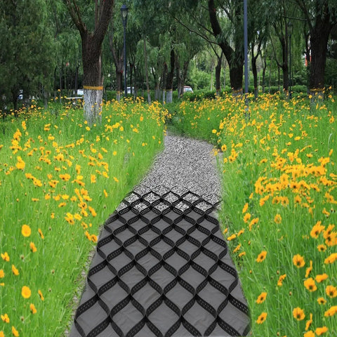 Hardcore Gravel Stabilizer Grid for Patios, Driveways and Slopes installed on path in garden, surrounded by wildflowers