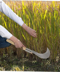 Person using Long Handle Manganese Steel Grass Sickle For Weeding And Harvesting All Purpose Garden Tool With Wooden Anti Slip Handle