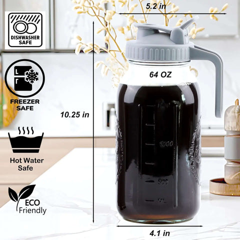 64 oz glass pitcher with handle, lid, and measurement markings, shown on kitchen counter. Dishwasher, freezer, hot water safe features visible.