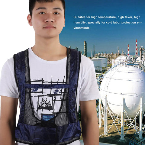 Adult Sleeveless Cooling Vest With Compressed Air Powered Vortex Tube Tech That Slays Kickin Summer Heat And Provides No Sweat Grind Comfort In Cool Cotton Oxford Blend For Peak Chill Factor Blue worn by a person near industrial setting.