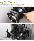 Cleaning the Super Dope 130Mm Wide Chute Masticating Cold Press Juicer under water with cleaning brush and dishwasher items.