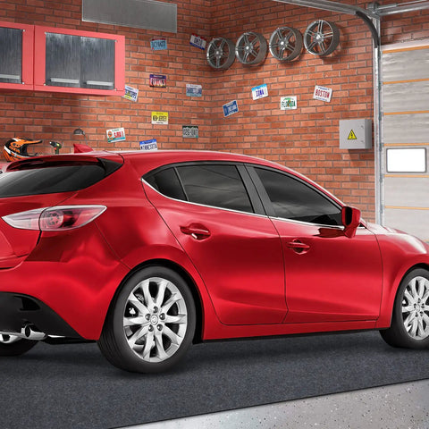 Oil Spill Mat For Garage Floor 7.4 By 8.4 Feet Premium Absorbent Pad With Waterproof Rubber Backing shown under a red car in a garage.