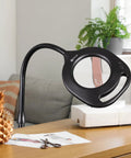 Two In One ClearSun LED Magnifier Light Floor And Table Lamp for crafting and sewing on a wooden desk next to sewing materials
