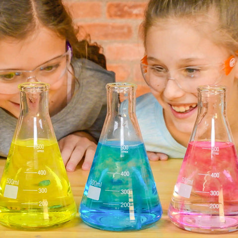 Kids experimenting with True Color Fizzers Tub Tint Tablets Pack For Water Coloring One Tablet Colors Up To A Liter in beakers