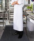 Chef standing on Anti Fatigue Drainage Rubber Floor Mat Roll 83 By 36 Inch Non Slip Heavy Duty For Kitchen Bar Restaurant Wet Areas With Holes