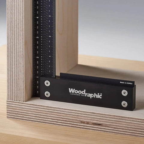 12 Inch Aluminum Woodworking Square For Framing And Layout Pro Carpenter Tool with ruler on wooden corner.
