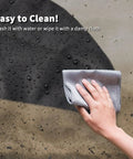 Close-up of cleaning waterproof Boss Level Heavy Duty Table Saw Cover for Bosch 10 Inch Saws With Wheeled Stand.