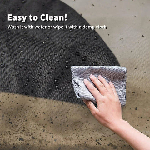 Person wiping heavy duty waterproof table saw cover made of oxford fabric, showcasing easy cleaning and water resistance.
