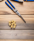 8pc Brass Furniture Legs For Wooden Trays And Boxes on wooden table with pliers