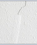 Self Adhesive Drywall Joint Tape 1.5 Inch By 32 Foot Textured Roll applied over crack on wall, blending with texture
