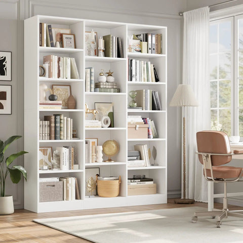 Triple Wide Bookshelf With Six Tier Storage And Seventeen Open Shelves In Pure White filled with books and decor in a bright living room