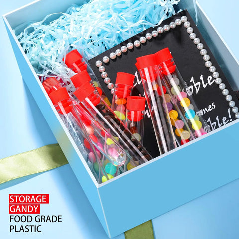 Gift box with 50 Pack Clear Plastic Test Tubes 16x100mm with Red Caps, featuring blue filling paper and accessories, for decoration and storage.