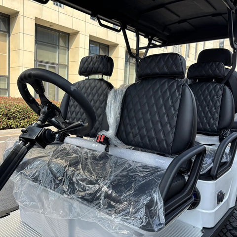 Interior of Six Seater Electric Leisure Cart With Premium Upholstered Interior, featuring quilted black seats and steering wheel.