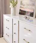Golden Champagne Riva Cabinet Pull 5 1/16 Inch Center To Center 5 11/16 Inch Overall Length on white dresser
