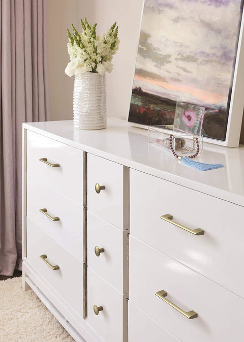 Golden Champagne Riva Cabinet Pull 5 1/16 Inch Center To Center 5 11/16 Inch Overall Length on white dresser
