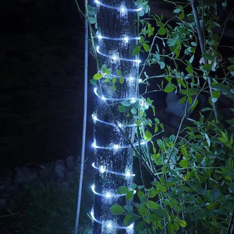 Solar Rope Lights Outdoor Waterproof 2 Pack 33ft 100 LED String Lights wrapped around tree trunk in garden at night