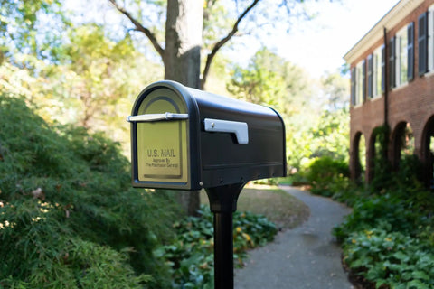 Chadwick Galvanized Steel Post Mount Mailbox Black 21 Inch with steel reinforced opening and cast aluminum handle in garden setting