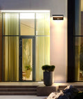 Solar Motion Sensor Outdoor Wall Light With 600 Lumen Output And 3 Modes mounted by entrance at night, IP44 aluminum, no wiring