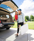 Woman carrying Compact Kids Picnic Table With Foldable Benches Under The Table And Built In Carry Handle For Easy Transport