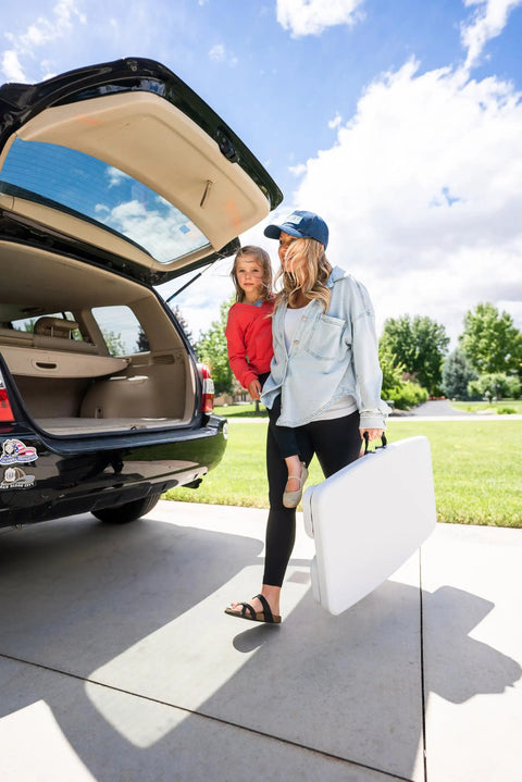 Woman carrying Compact Kids Picnic Table With Foldable Benches Under The Table And Built In Carry Handle For Easy Transport