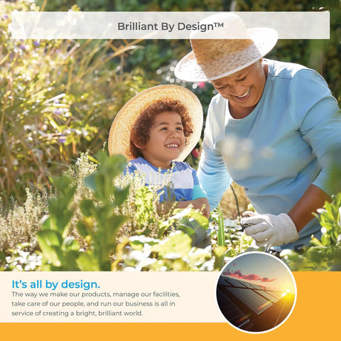 Person gardening with child, both wearing hats, in a sunlit garden with lush greenery.