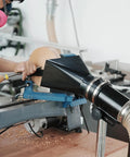 Premium Woodturning Dust Extraction Hood featuring flexible rubber cuff mounted on lathe with wood chips flying.