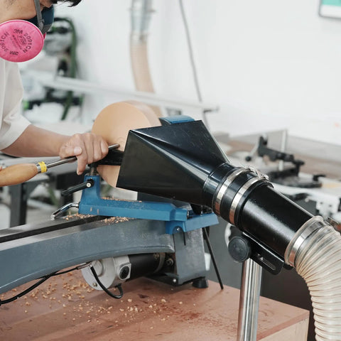 Premium Woodturning Dust Extraction Hood featuring flexible rubber cuff mounted on lathe with wood chips flying.