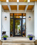 Front view of a porch with Large 14 Inch Outdoor Wall Lantern With Wood Grain Finish And Clear Glass Anti Rust Exterior Sconce