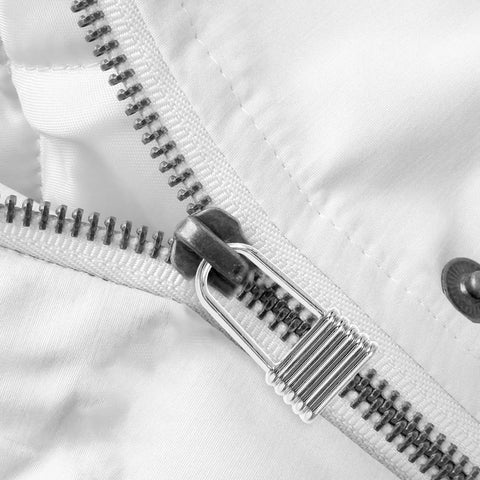 Close-up of Heavy Duty Metal Zipper Pull Tabs For Backpack Repair Silver Replacement Sliders on white fabric.